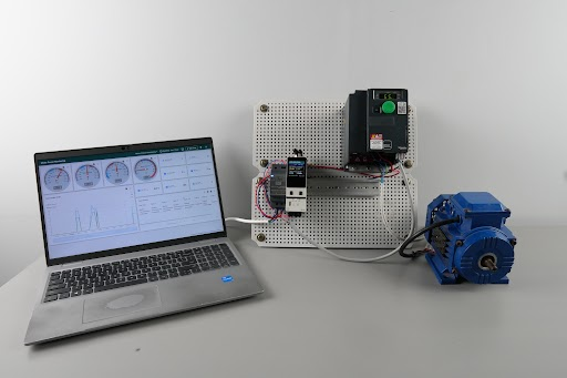 Figure 2 - Bench setup: NORVI CPU-ESPS3-X2 with TFT display (left, on breadboard), ATV320 VFD and RS-485 module (center panel) wired to a motor (right), monitored live from a laptop dashboard.